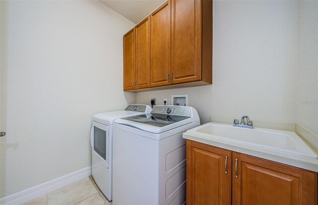 laundry room with cabinets, hookup for a washing machine, washer and dryer, light tile floors, and hookup for an electric dryer