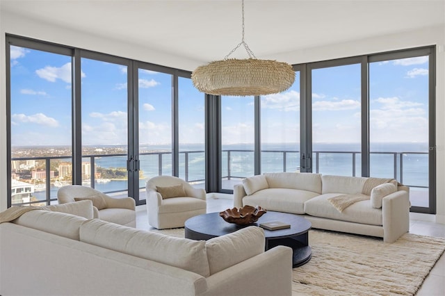 living room with a water view and a healthy amount of sunlight