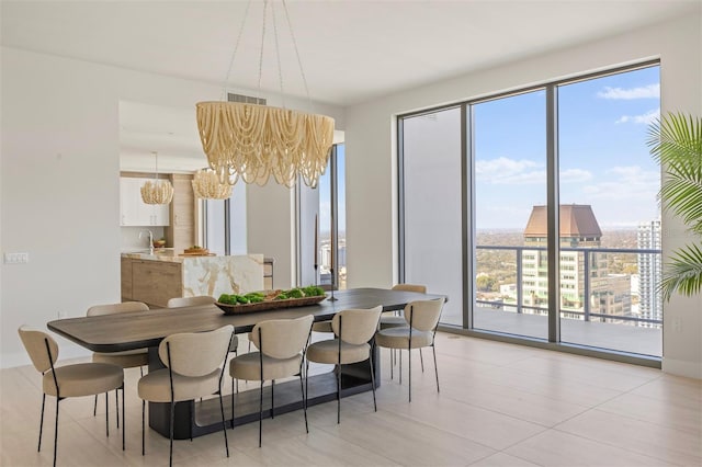 dining area with light tile flooring and an inviting chandelier