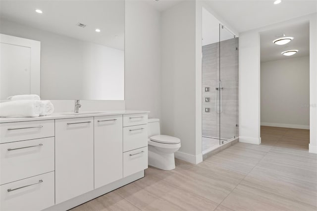 bathroom with toilet, a shower with door, tile flooring, and vanity