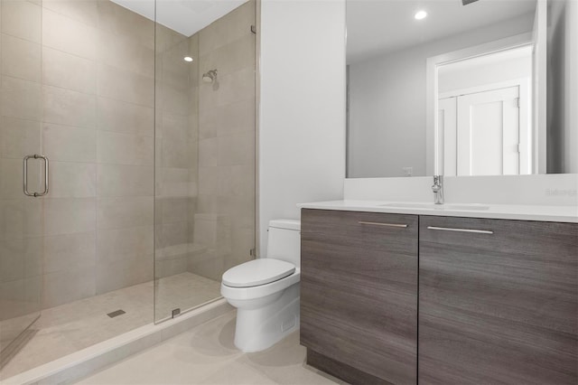 bathroom featuring vanity, tile floors, a shower with door, and toilet