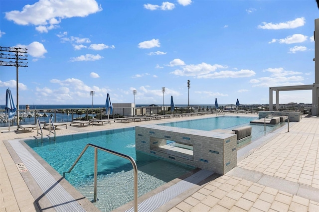 view of pool with a jacuzzi