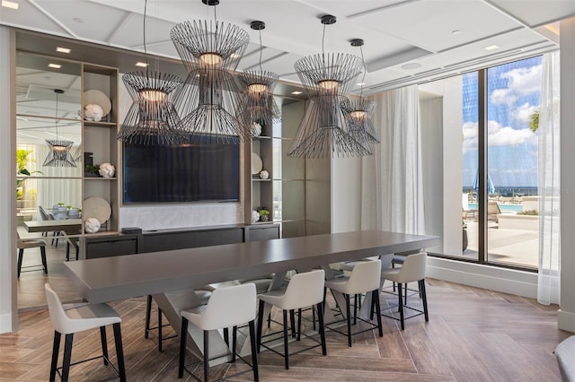 bar featuring pendant lighting, an inviting chandelier, parquet floors, and a tray ceiling