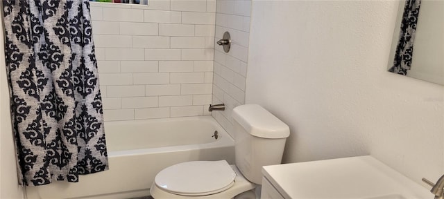 bathroom featuring shower / bath combination with curtain and toilet