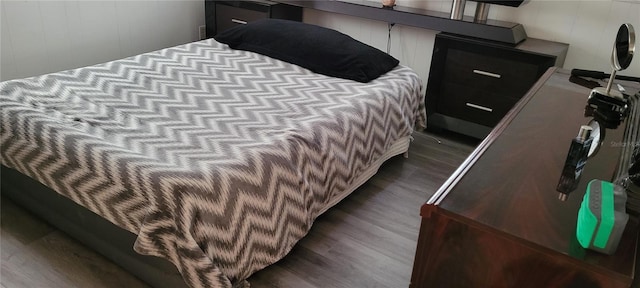 bedroom with dark wood-type flooring