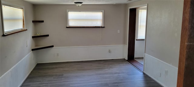 spare room featuring dark hardwood / wood-style flooring