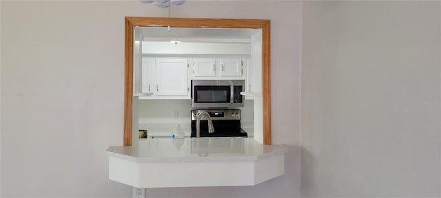 kitchen featuring white cabinetry and stainless steel appliances