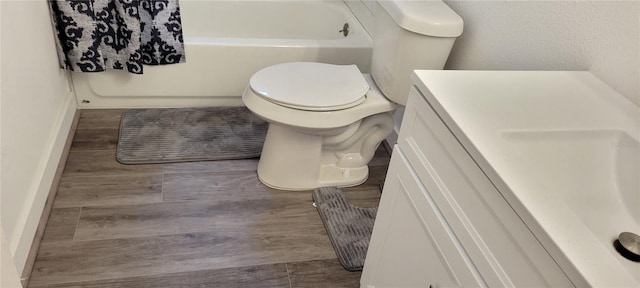 bathroom featuring vanity, toilet, and hardwood / wood-style floors