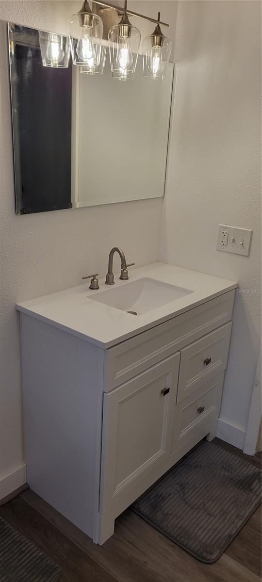 bathroom with vanity and hardwood / wood-style floors