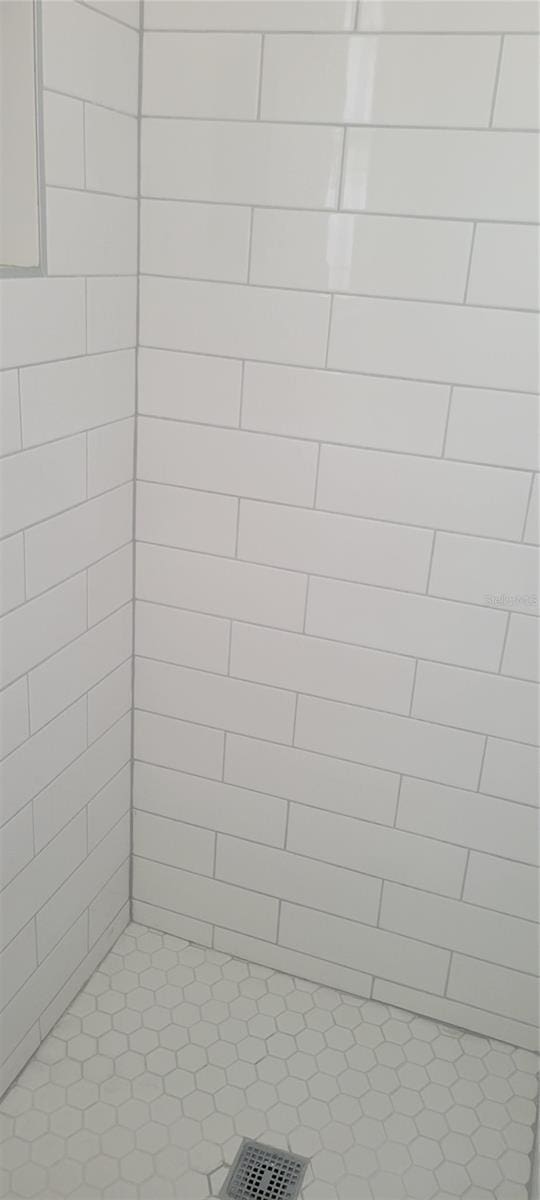 bathroom with a tile shower