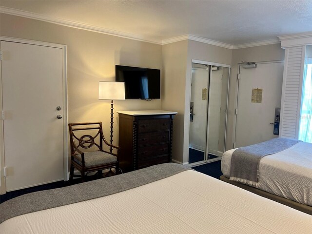 carpeted bedroom featuring crown molding