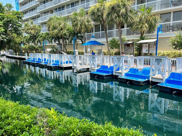 dock area with a balcony and a water view