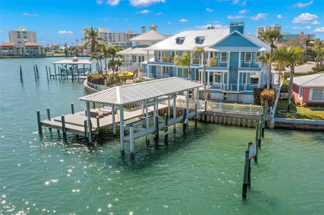 dock area with a balcony and a water view