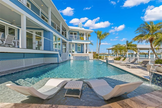 view of pool featuring pool water feature and a patio