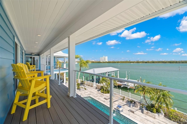 wooden terrace featuring a water view