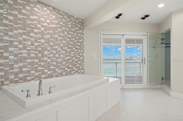 bathroom with plus walk in shower and tile walls