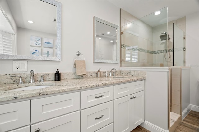 bathroom with vanity, hardwood / wood-style flooring, and an enclosed shower