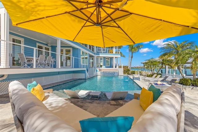 view of swimming pool with outdoor lounge area and a patio