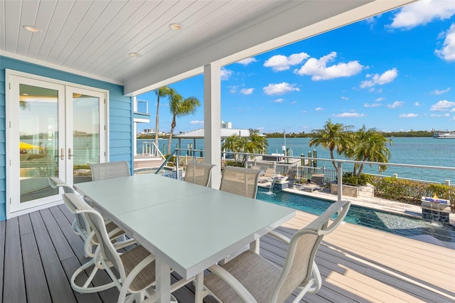 deck with pool water feature, french doors, and a water view