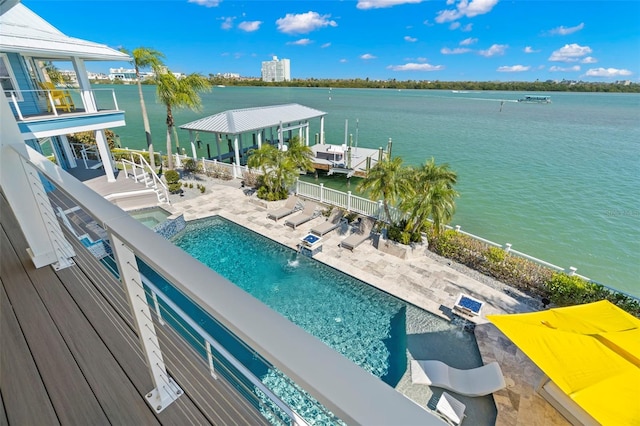 view of pool with a patio area and a water view