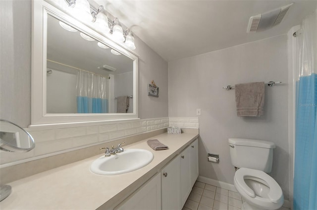 bathroom with curtained shower, tasteful backsplash, tile patterned flooring, toilet, and vanity