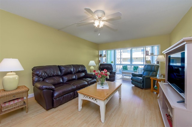 living room featuring ceiling fan and light hardwood / wood-style flooring