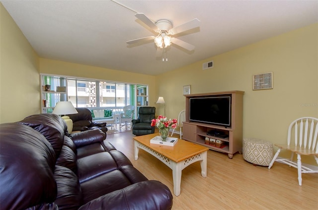 living room featuring ceiling fan and light wood-type flooring