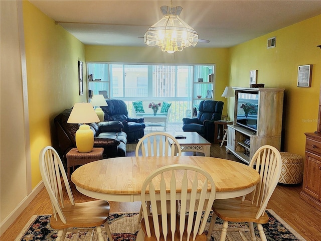 dining room with a chandelier and light hardwood / wood-style floors