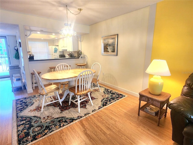 dining room featuring a chandelier and light hardwood / wood-style flooring