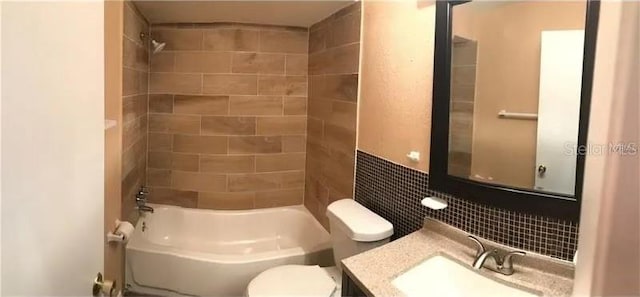 full bathroom featuring toilet, tiled shower / bath combo, and vanity