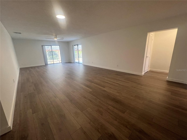 empty room featuring dark hardwood / wood-style flooring