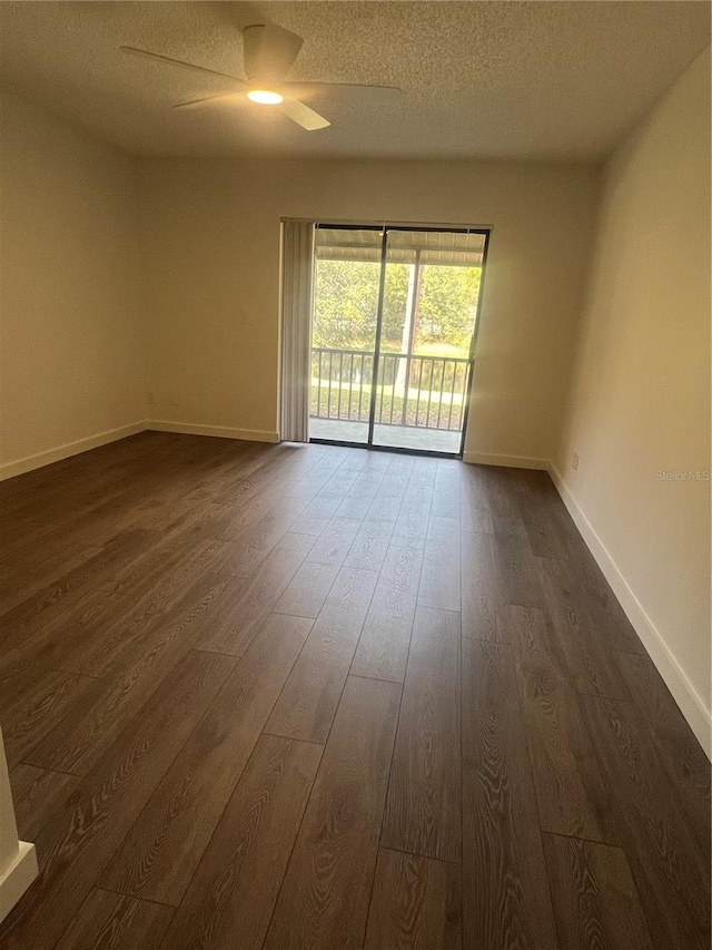 spare room with ceiling fan, dark wood-type flooring, and a textured ceiling