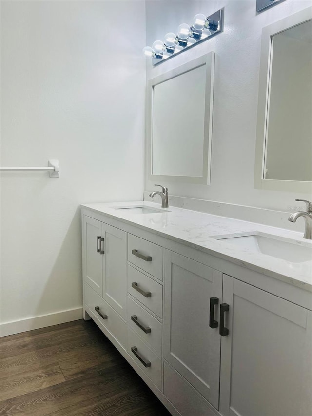 bathroom with hardwood / wood-style floors and dual bowl vanity