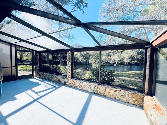 unfurnished sunroom featuring a water view and a wealth of natural light