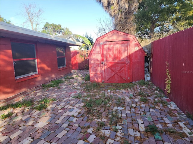 view of yard featuring a patio and a storage unit