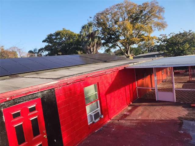 view of side of property with solar panels