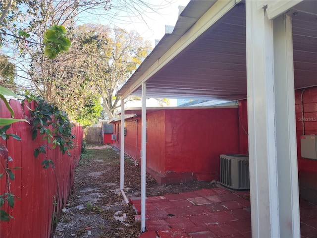 view of side of home with central air condition unit