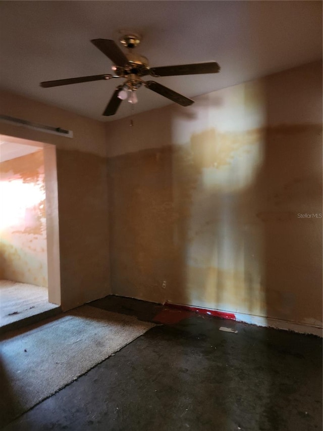 spare room with concrete floors and ceiling fan