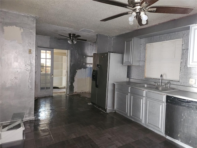 kitchen featuring ceiling fan, gray cabinets, sink, dishwashing machine, and stainless steel refrigerator with ice dispenser