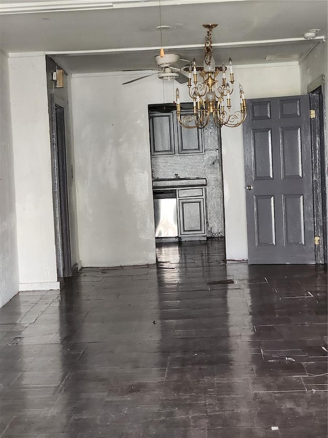 interior space featuring ceiling fan with notable chandelier and dark hardwood / wood-style flooring