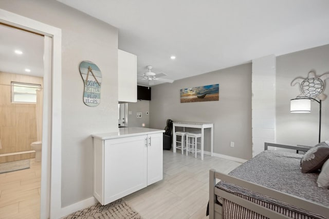 bedroom with ceiling fan and ensuite bath