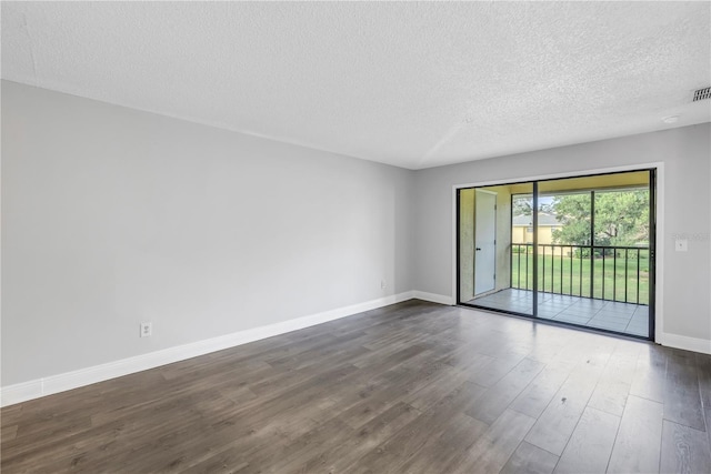 unfurnished room featuring a textured ceiling and dark wood-type flooring