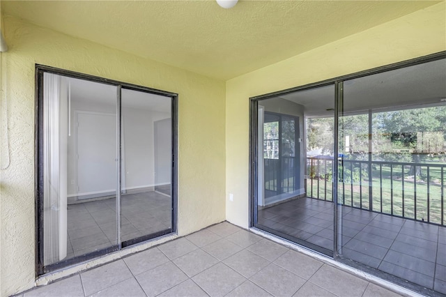 interior space featuring light tile floors and a textured ceiling