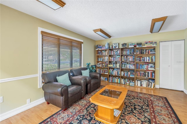 sitting room featuring a textured ceiling and light wood-type flooring