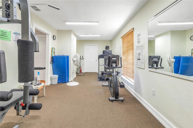 workout room featuring dark carpet