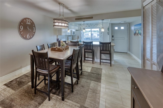 dining room with an inviting chandelier and light tile flooring