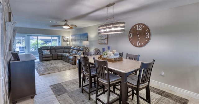 dining room with ceiling fan with notable chandelier and light tile floors