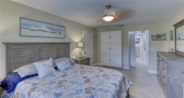 tiled bedroom featuring a closet and ceiling fan