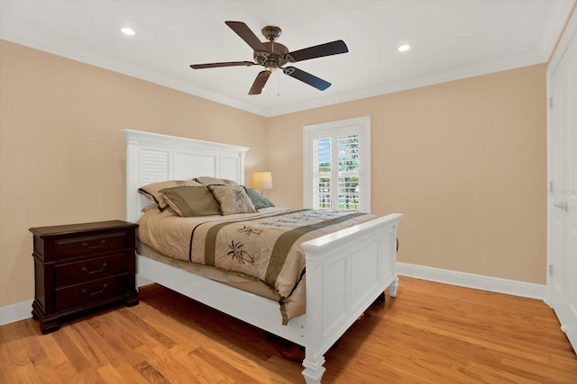 bedroom with ceiling fan, ornamental molding, and light wood-type flooring