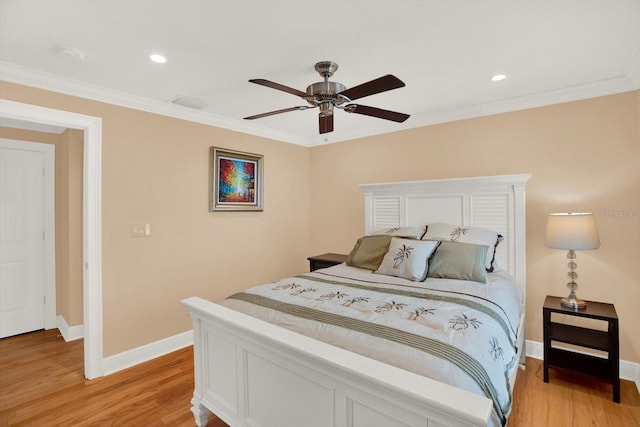 bedroom featuring ceiling fan, ornamental molding, and light wood-type flooring